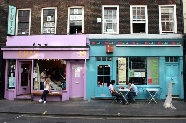 two street shop fronts in pastel blue and pink.